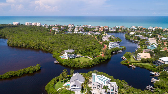 Houses around a river in Bonita Springs that leads to the ocean.