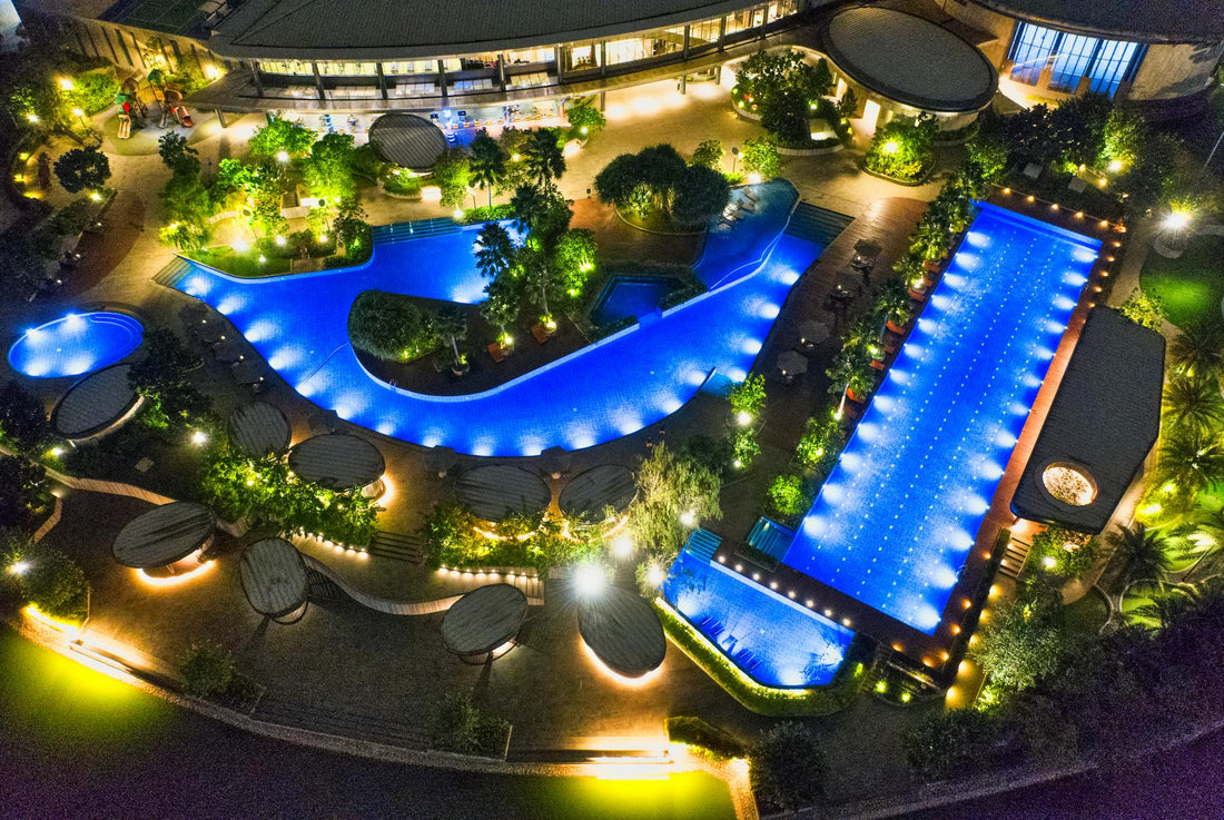 Backyard pools with many lights and landscaping