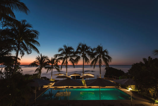 Wide angle shot of lit pool after sunset